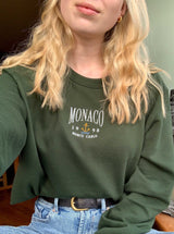 Monaco embroidered design onto forest green sweatshirt. Styled with high waisted jeans. 