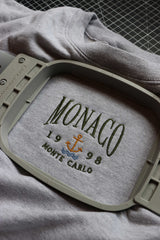 Monaco design on grey sweatshirt within embroidery hoop.